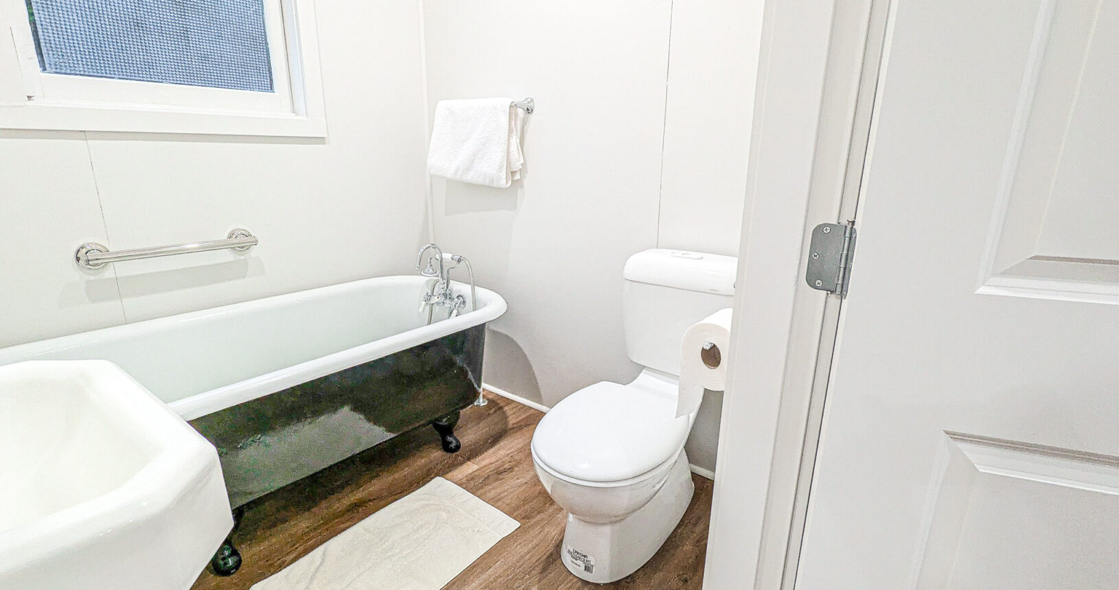 Bathroom with Antique Restored Clawfoot Tub and Sink and modern low flow toilet
